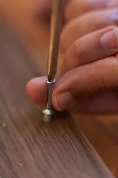 Man's hands hold screw while adjusting it. Assembling furniture at home. Carp Stock Photos
