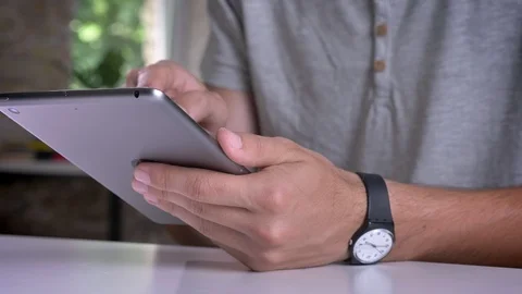 Man's hands holding and typing on tablet in modern office Stock Footage 92666712