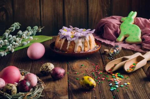 Man's hands holding Easter ring cake over wooden background Stock Photos