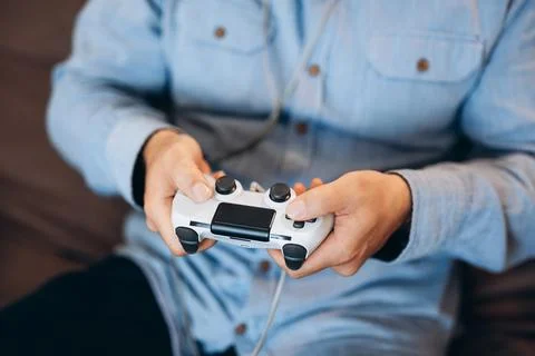 Man's hands holding game controller. Close up. Good time on weekend concept. Cut Stock Photos