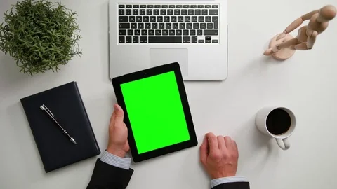 A Man's Hands Holding an i-Pad with a Green Screen Stock Footage 83716787