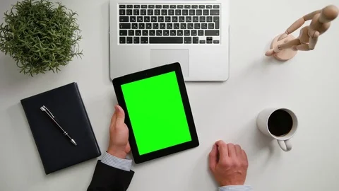 A Man's Hands Holding an i-Pad with a Green Screen Stock Footage 83716944