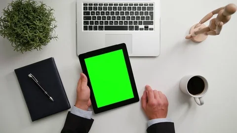 A Man's Hands Holding an i-Pad with a Green Screen Stock Footage 83717311
