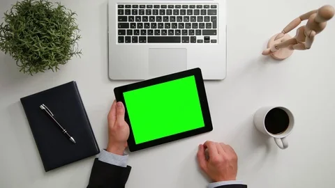 A Man's Hands Holding an i-Pad with a Green Screen Stock Footage 83723631