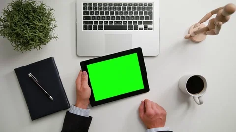 A Man's Hands Holding an i-Pad with a Green Screen Stock Footage 83724095