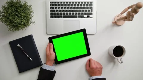 A Man's Hands Holding an i-Pad with a Green Screen Stock Footage 83724393