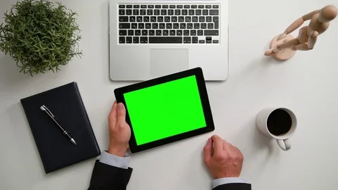 A Man's Hands Holding an i-Pad with a Green Screen Stock Footage 83724765