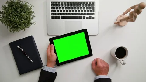A Man's Hands Holding an i-Pad with a Green Screen Stock Footage 83725701