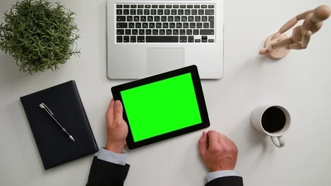 A Man's Hands Holding an i-Pad with a Green Screen Stock Footage 83725893