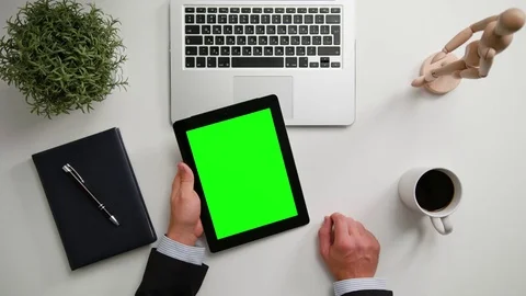 A Man's Hands Holding an i-Pad with a Green Screen Stock Footage 83745121