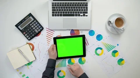 A Man's Hands Holding an i-Pad with a Green Screen Stock Footage 84176525