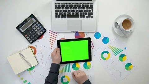 A Man's Hands Holding an i-Pad with a Green Screen Stock Footage 84274199