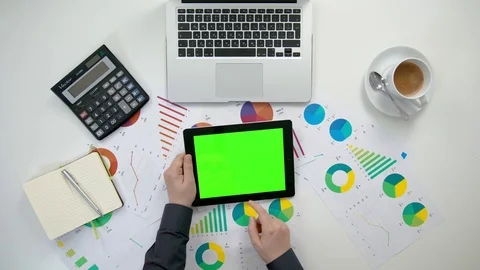 A Man's Hands Holding an i-Pad with a Green Screen Stock Footage 84277752