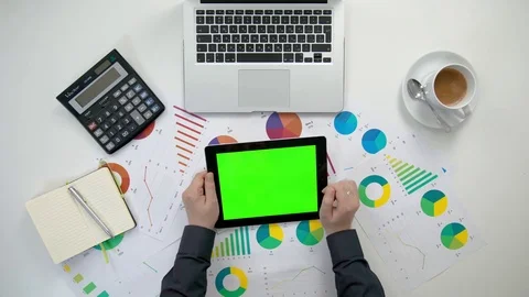 A Man's Hands Holding an i-Pad with a Green Screen Stock Footage 84281805