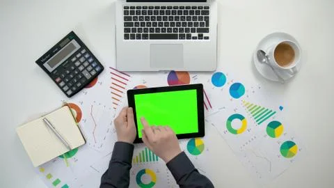 A Man's Hands Holding an i-Pad with a Green Screen Stock Photos