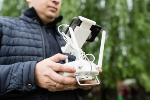 Man's hands holding remote control of drone. Using technology Foto stock