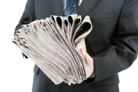 Man's hands holding a stack of newspapers Foto stock