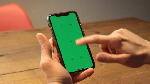 A man's hands holds a green screen smartphone. Close-up. Stock Footage 170957790