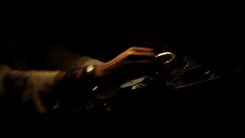 A man's hands inserting a vinyl record into an mechanical patiphone, putting on Stock Footage 241748673