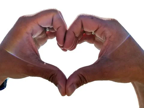 Man's hands isolated on a white background folded into a heart symbolizing lo Stock Photos
