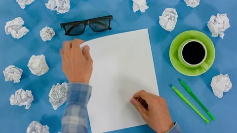 The man's hands make notes in the storyboard, in the final paper is crumpled Stock Footage 77374345