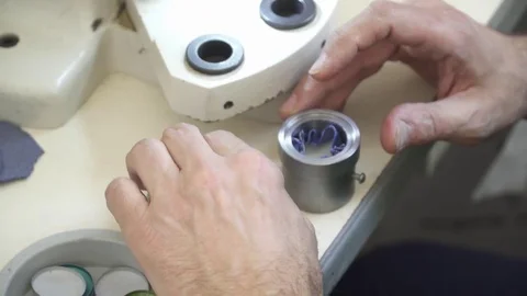Man's hands making buttons on the clothing factory Stock Footage 74427447