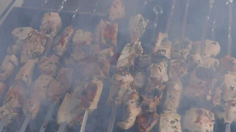 Man's hands move meat on the grill. Fried meat with smoked meat on the grill. Cl Stock Footage 120608511