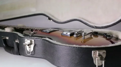 Man's hands open a case and takes a guitar out of a case. Stock Footage 57747048