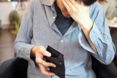 Man's hands open empty purse. Poverty, debt and bankruptcy in the payment of  Fotos Stock