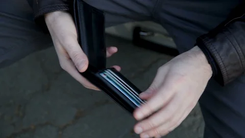 A man's hands open his wallet and find just a few coins Stock Footage 102282507