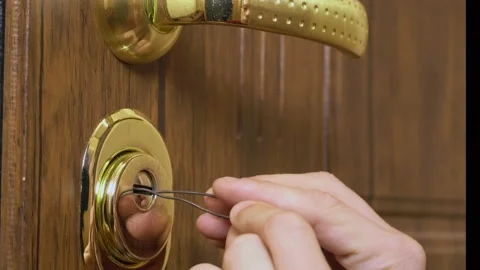 The man's hands open the lock with a master key Stock Footage 148781548