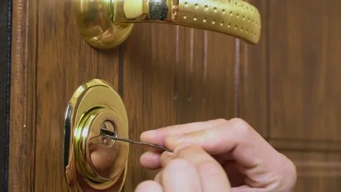 The man's hands open the lock with a master key 库存影片 148781568