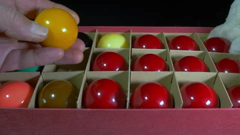 Man's hands opening a box set of snooker balls. Stock Footage 245925866