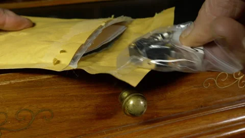 A man's hands opening a padded bag shipping package. Video stock 257590815