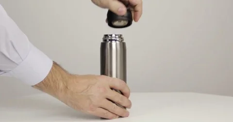 Man's hands opening thermos Stock Footage 83911666