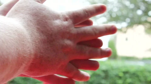 Man's Hands, Out Of Focus Greenery In Background Stock Footage