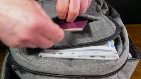 Man's hands packing personal items into a backpack. Stock-Footage 146599880