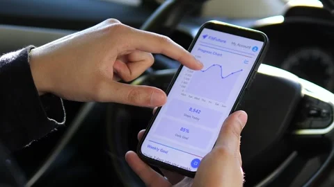 A mans hands in a parked car interact with a comprehensive health application Video stock 318947328