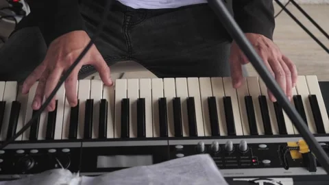 A man's hands play the piano Stock Footage 170939406