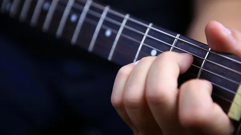 Mans hands playing chords on electric guitar progression from a minor to c to Video stock 96722748