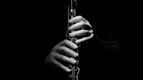 Man's hands playing the clarinet Stock Photos