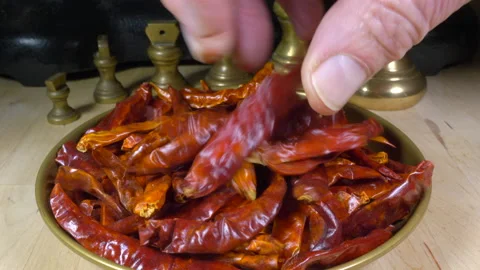 Man’s hands preparing to weigh dry red chillis on traditional mechanical scales. Stock Footage 145578693