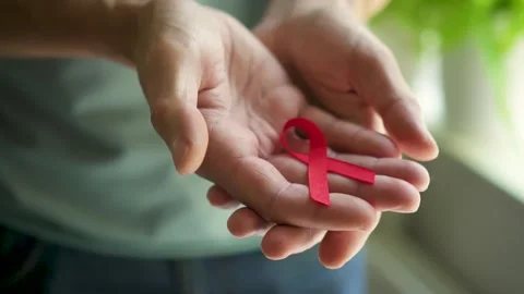Mans Hands Presenting Red HIV AIDS Awareness Ribbon Stock Footage 316753965