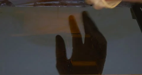 Man's Hands in Protective Gloves Making The Etching of a Copper Plate in Acid Stock Footage 53376917