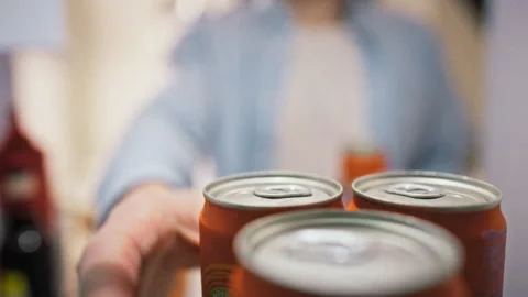 Mans hands pull several cans of sparkling water from open refrigerator door Stock Footage 337937481