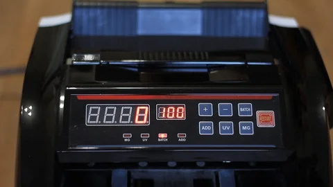 Man's hands put dollars in electronic money counter. electronic money counter Stock Footage 128122118