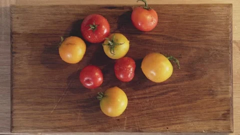 Man's hands put organic tomatoes on a cutting board. Stock Footage 161815996