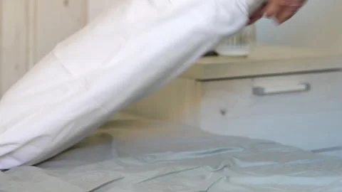 Man's hands putting fresh white pillowcase on a pillow in the bedroom Vidéo 341581627