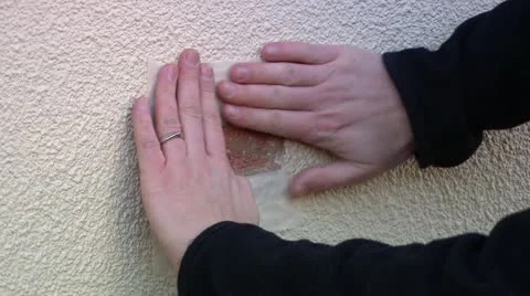 Man's hands putting tape on wall Stock Footage 11924850
