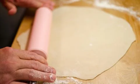 A mans hands rolling out dough Stock Photos